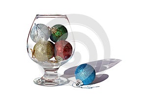 Christmas toys in a glass cup on a white background