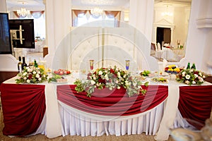 Decor of a wedding party. Wedding table decoration in a restaurant. Glasses, drinks, food. Festive decoration of the interior