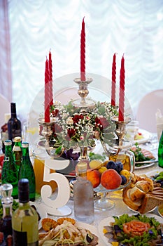 Decor of a wedding party. Wedding table decoration in a restaurant. Glasses, drinks, food. Festive decoration of the interior
