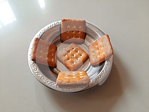 Decorate biscuits in steel bowl.