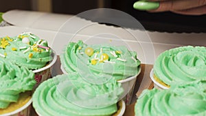 Decorate lemon cupcakes with mint cream multi-colored sugar sprinkle