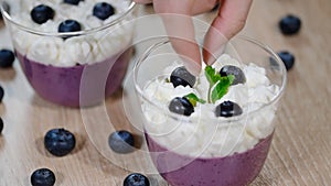 Decorate with mint leaves blueberry Panna cotta in a glass