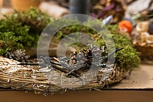 Decorated Advent wreath made of moss, dried flowers and fruits