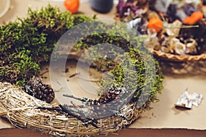 Decorated Advent wreath made of moss, dried flowers and fruits
