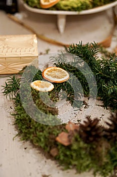 Decorated Advent wreath made of moss, dried flowers and fruits