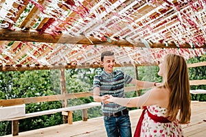 Decorated arch, tent, awning, canopy, scene, red, white decor paper, Confetti. Wedding. pregnant woman, husband Dancing