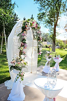 Decorated archway for wedding ceremony with colorful flowers