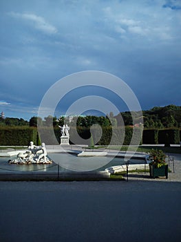 Decorated baroque fountain and stormclouds photo