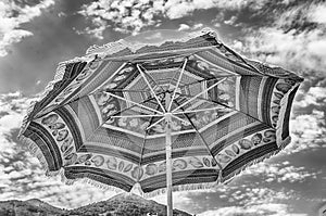 Decorated beach umbrella against the background of a light sky