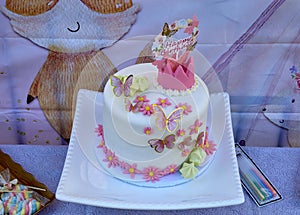 Decorated birthday cake with butterflies on a table at the marina Brooklyn Bridge Park, Brooklyn New York City, New York USA