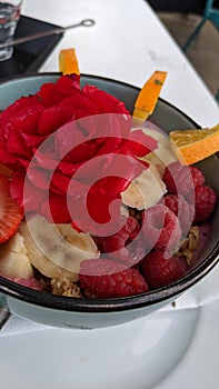 Decorated bowl with granola, yoghurt, fruits and berries