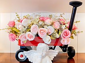 Decorated Bunch of Roses in Red Cart with White Angel Figure in front with Space Above to Input Text