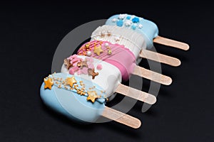 decorated cake pops ice creams on black background