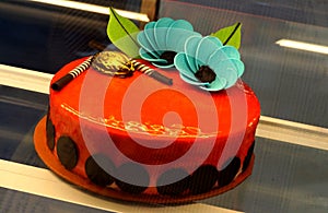 Decorated cake in refrigerated display unit of a bakery shop