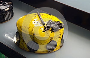 Decorated cake in refrigerated display unit of a bakery shop