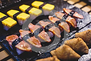 Decorated catering banquet table with different asian sushi rolls and nigiri sushi plate assortment on a party