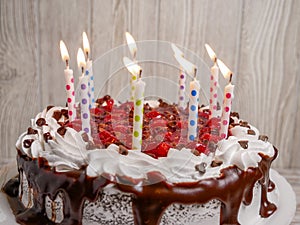 Decorated chocolate cherry cake with candles