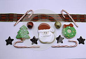 Decorated Christmas cookies with candy canes ribbon and chocolate stars, isolated