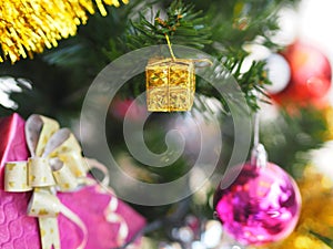 Decorated Christmas green tree decorations have Gift box gold red ball hanging pine, leaves on blurred of background