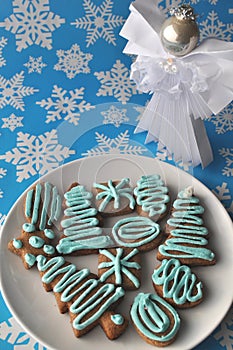 Decorated Christmas honey cookies on winter background with snowflakes