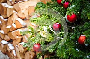 Decorated christmas tree on chopped wooden stack background