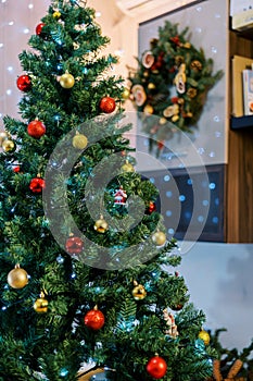 Decorated Christmas tree with colorful balls, toys and sparkling garlands