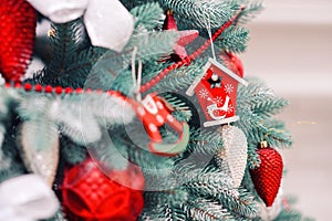 Decorated christmas tree with different colourful toys on it. Happy winter holidays.