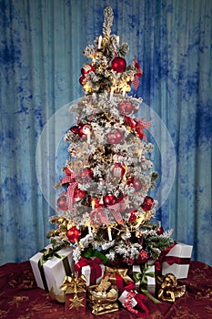 Decorated christmas tree with electric candles and presents