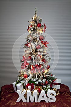 Decorated christmas tree with electric candles and presents