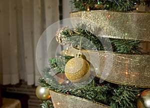 Decorated Christmas tree with golden baubles and ribbons