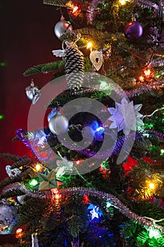 Decorated christmas tree with lights on red background