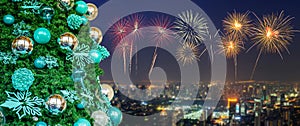 Decorated Christmas tree on New Year colorful fireworks with cityscape skyline in night time background