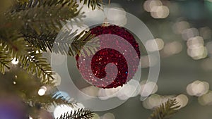 Decorated Christmas tree over blurred night city lights at the celebration party