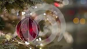 Decorated Christmas tree over blurred night city lights at the celebration party