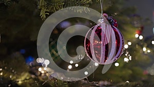 Decorated Christmas tree over blurred night city lights at the celebration party