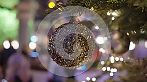 Decorated Christmas tree over blurred night city lights at the celebration party