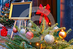 Decorated Christmas tree with picture frame for labelling in the background