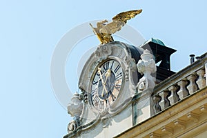 Decorated clock and golden eagle on top of SchÃ¶nbrunn palace