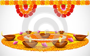 Decorated Diwali Diya on Flower Rangoli photo