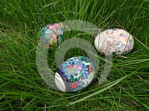 Decorated Easter eggs lie in the green grass