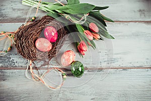 Decorated eggs and tulips on the wood