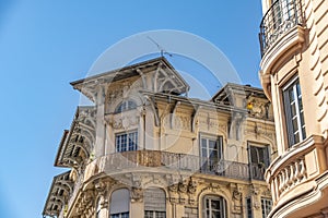 Decorated facade of a historic house in Nice, France. You can see the typical windows, balconies and shutters of a Mediterranean c