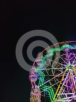 Decorated Ferris wheel in traditional market, Indonesia.