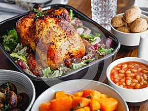 Decorated festive table with whole roasted chicken