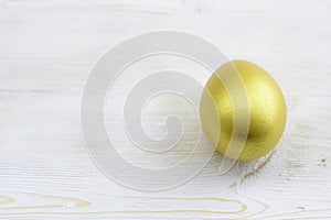 Decorated with gold glitter easter egg on a wooden table