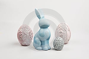 Decorated gypsum eggs for Easter and blue bunny