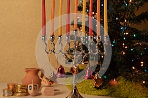 Decorated Hanukkah menorah, Christmas tree, spinning top toys and chocolate coins