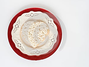 Decorated Heart Cookie on lacy White Plate on Red Plate