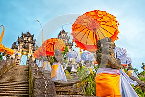 Decorated for the holiday Galungan statue of a Balinese temple. Bali, Indonesia. Close up