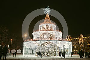 Decorated and illuminated Christmas tree on the Cathedral Square at night in Vilnius. Celebrating Christmas and New Year in